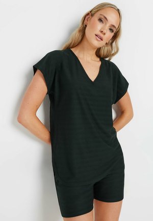 Black, short-sleeved v-neck top with a loose fit, paired with matching shorts. Soft fabric with subtle vertical stripes and side pockets.