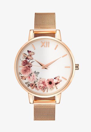 Montre bracelet en or rose avec bracelet en maille, cadran blanc ornée d’un motif floral et papillon rose, chiffres romains à 12 et 6 heures, et index dorés.