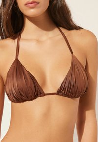 Brown bikini top made of shiny fabric, featuring a triangle shape with pleated texture and thin adjustable straps.
