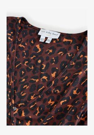 Brūns audums ar melnu un oranžu leoparda raksta rakstu. V-veida kakla izgriezums ar gludu tekstūru un etiķeti, kurā norādīts izmērs un zīmols.