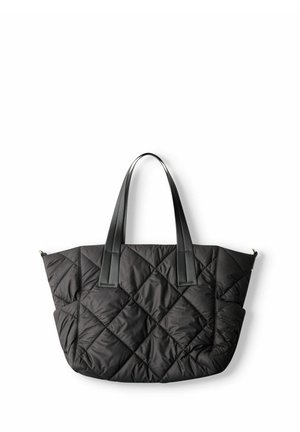 Sac fourre-tout noir matelassé avec surpiqûres en losange et deux longues poignées en cuir, présenté sur fond blanc.
