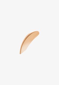 Oggetto curvo di colore beige con una superficie liscia e opaca; termina con un bordo fine. Design leggero e minimalista, adatto per un uso ergonomico.
