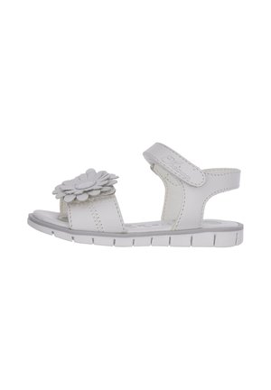 Sandalo bianco con decorazione a fiore, caratterizzato da una punta aperta e cinturino regolabile. Realizzato in materiale sintetico con superficie testurizzata.