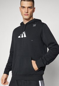 adidas Performance FB CAT GRAPHIC HOODIE - Jersey con capucha - black