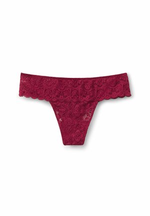 Spitzenstring in sattem Burgunderrot, mit floralem Muster und gewellten Kanten. Leichtes Material verleiht eine zarte Textur und Designakzente.