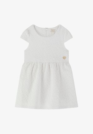 Valge kleit tekstuursete geomeetriliste mustritega, lühikeste varrukatega ja volditud seelikuga. Omab seljaampu ja väikest südame logo rinnal.