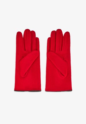 Czerwone wełniane rękawice o gładkiej fakturze, z zaokrąglonymi końcówkami i miękkim akcentem przy nadgarstku.