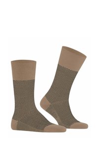 Beige Socken mit einem gerippten Bündchen und einem Fischgrätmuster in Dunkelbraun über dem gesamten Socken, entworfen für Komfort und Vielseitigkeit.
