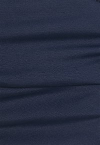 Navy blue fabric with a ribbed texture, featuring horizontal folds. Material appears stretchy and smooth with a subtle sheen.