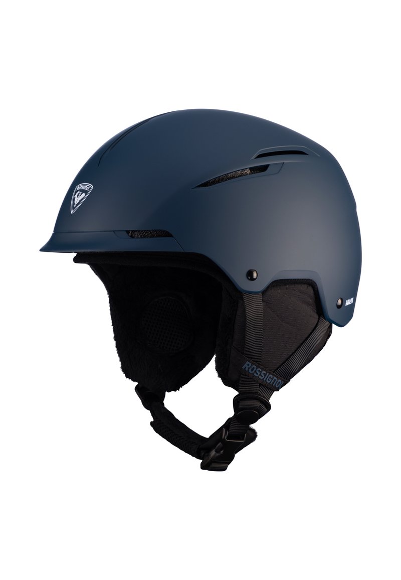 Tummansininen hiihtokypärä, jossa on matta pinta. Varustettu tuuletusaukoilla, pehmeillä korvatyynyillä ja säädettävällä leukahihnalla. Logo etupinnassa.