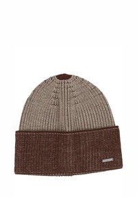 Neulottu pipo, jossa on kerma- ja ruskean sävyjä. Pipossa on taitettu reuna, jossa on teksturoitu kuvio ja pieni metallinen logokoriste.