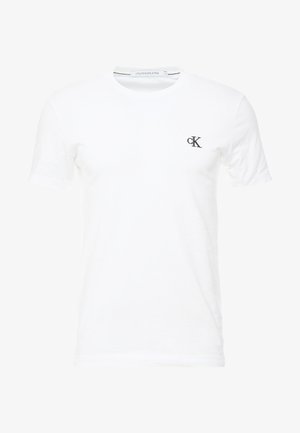 Lihtne valge lühikeste varrukatega T-särk ümar kaelusega, väike must "cK" logo ülemisel vasakul rinnal, Calvin Klein Jeans silt kaeluse sees.