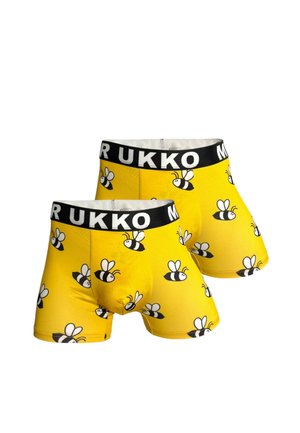 Twee gele boxershorts met zwarte taillebanden waarop "MUKKO" staat, versierd met een herhalend patroon van zwart-witte cartoonbijen.