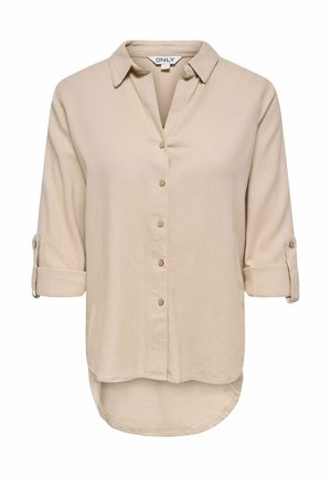Chemise beige à manches longues avec boutons, col, manches retroussables, ourlet arrondi et étiquette de la marque "ONLY" à l'intérieur du col.