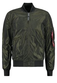Olive green bomber jacket with a zip front, ribbed cuffs and hem, side pockets, and a pocket on the sleeve with a red tag detail.