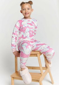 Pink pajama set with cartoon character patterns, made from soft fabric. Features long sleeves and fitted pants with pink cuffs. U-shaped slippers.