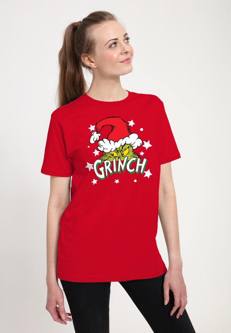 Červené tričko s krátkým rukávem s motivem Zeleného Grinche v santovské čepici, zdobené bílým umělým kožíškem a hvězdami.