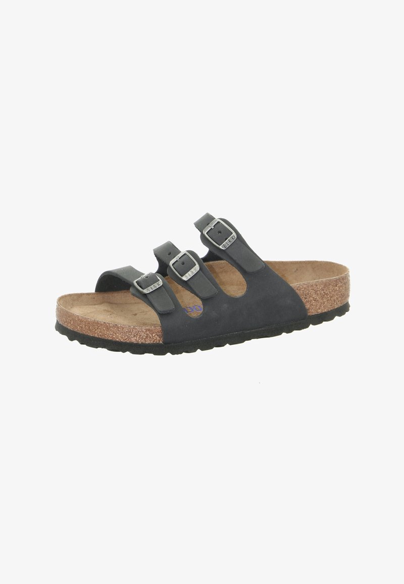 Black leather sandal with three adjustable buckles, cork footbed, and textured rubber sole. Open design with rounded toe and contoured shape.