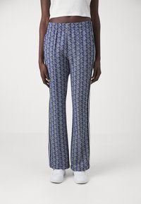 Blue patterned pants with a geometric design, an elastic waistband, and white side stripes. Made from a soft fabric with a relaxed fit.
