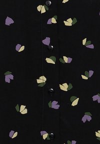 Black fabric with a floral pattern featuring purple, yellow, and green shapes. Four black buttons visible down the center.