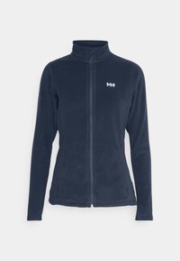 Fleecejack in marineblauw met een hoge kraag, volledige rits en een logo-accent op de linkerkant van de borst. Zachte textuur, slanke pasvorm en lange mouwen.