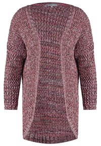 Dlouhý svetr s rukávy vyrobený z texturované pleteniny v odstínech růžové a bílé, s otevřeným předním dílem a bočními rozparky pro pohodlný pohyb.