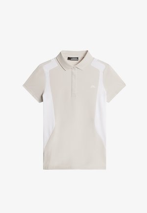 Vaaleanbeige polo-paita, jossa on valkoiset sivupaneelit, lyhyet hihat ja kaulus. Valmistettu sileästä kankaasta, edessä on pieni logo.