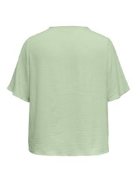 Blusa de manga corta verde claro con tela texturizada y un ajuste relajado y suelto, vista desde atrás.