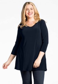 Navyblauwe tuniek met een V-hals en driekwartmouwen, met een losse, vloeiende uitstraling. Zachte stof met een gladde textuur.