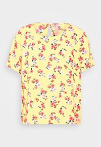 Květinový krátký rukáv top v žluté látce s růžovými a bílými květinami. Kulatý výstřih s otvorem ve tvaru klíče na zadní straně.
