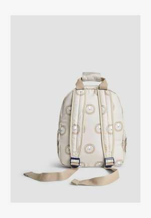 Detský batoh v krémovej tkanine s polstrovaným dizajnom, zdobený vzorom leva, s nastaviteľnými béžovými popruhmi a hornou prenosnou rukoväťou.