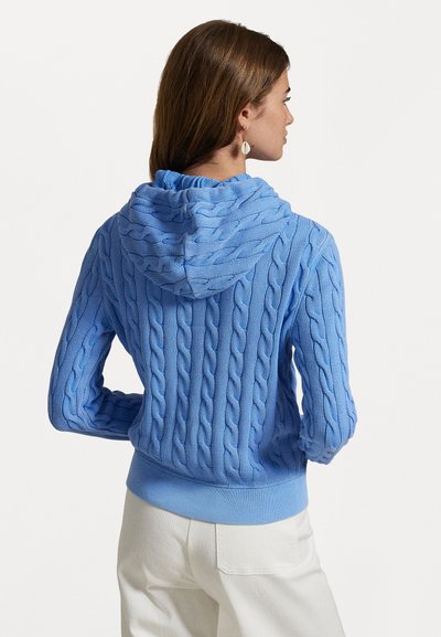  Lichtblauwe kabelgebreide hoodie met een textuurontwerp, lange mouwen en geribbelde zoom. Gestyled met lichte broek.