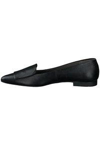Mocassin en cuir noir avec un bout pointu, présentant un talon plat et une texture en relief sur le dessus. Design minimaliste sans embellissements.
