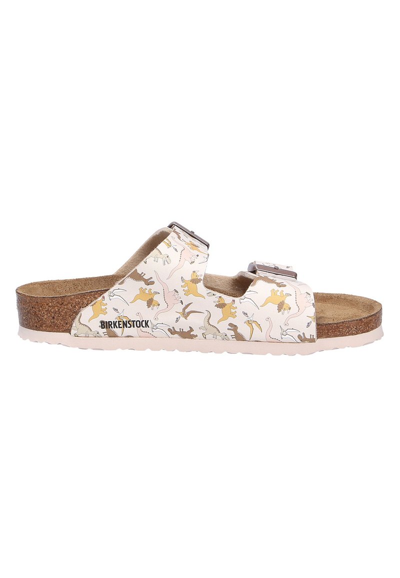 Sandales Birkenstock avec une tige blanche ornée d'un motif de dinosaures ludique, semelle en liège, double brides réglables et semelle extérieure en caoutchouc.