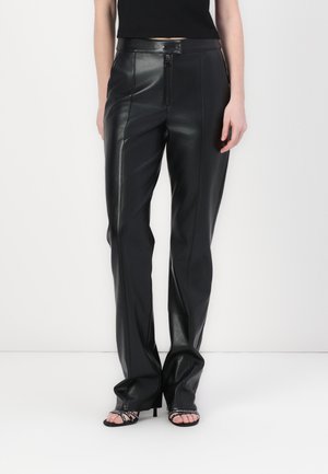 Black leather trousers with a smooth texture, zip closure, and tailored shape. Features a high waist and flared legs.