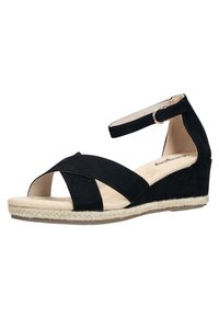 Sandalia de cuña negra de ante con tiras cruzadas, puntera abierta, correa ajustable en el tobillo y suela envuelta en yute. Detalle de plantilla suave en color beige.