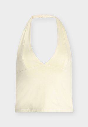 Cream-colored halter top with deep V-neck and wide straps tied at the back, displayed against a plain light background.