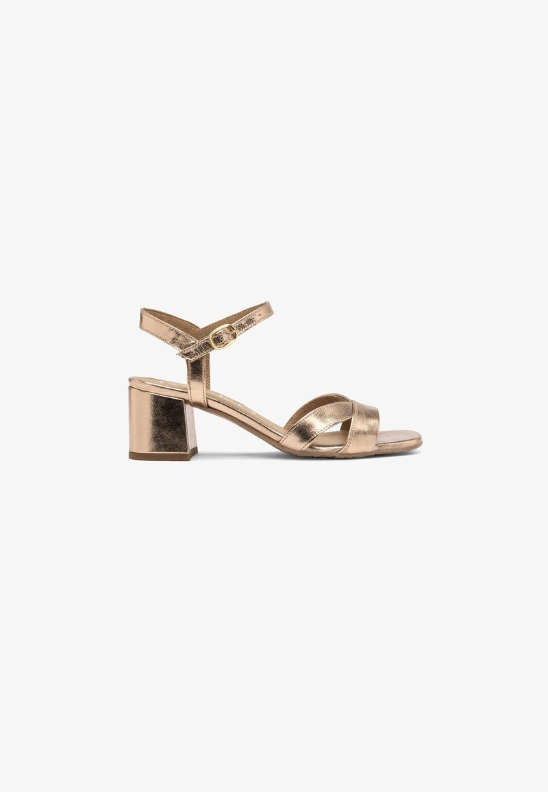 Gold metallic strappy sandal with a block heel, featuring cross straps, an adjustable ankle strap, and a smooth textured finish.