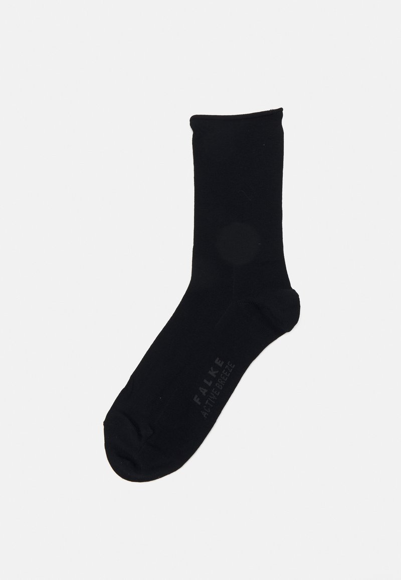 Svart ankelstrømpe laget av et glatt, elastisk materiale. Har forsterket tå og subtil branding på siden.