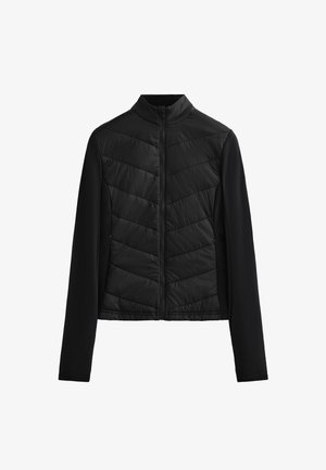 Black jacket featuring a zip front, high collar, and chevron quilted pattern on the front, with smooth fabric on the sleeves and sides.