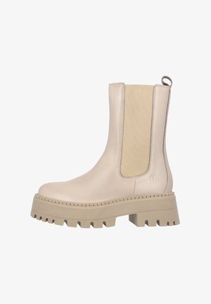Bottines beiges avec une tige en cuir lisse, des panneaux élastiques sur les côtés et des semelles en caoutchouc épaisses dotées d'un motif de crampons découpé.