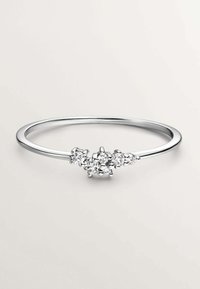 Anillo de plata con una banda lisa y minimalista que presenta cinco piedras preciosas transparentes agrupadas, destacando un diseño sutil y una superficie reflectante.