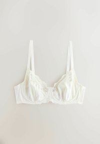 Hvid bh med blondekant, blødt satinmateriale, bøjleunderstøttelse, justerbare stropper og en bølget kant på blondedetaljen.