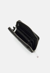 Black leather wallet with a zip-around closure, multiple card slots, and a central zippered pocket. Textured interior with silver hardware.