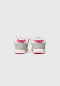 Gray suede sneaker with white mesh tongue, pink heel accent, and cream rubber sole. Black logo on the heel and tongue. Minimalist design.