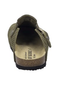 Olive green, textured fabric slip-on shoe with a curved back, cork footbed, black rubber sole, and silver buckle accent on the side.