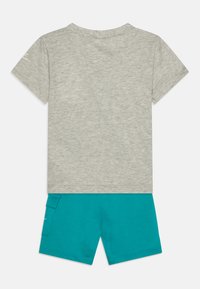 Gray cotton T-shirt with short sleeves and round neckline paired with teal shorts featuring a side pocket and a smooth, soft texture.