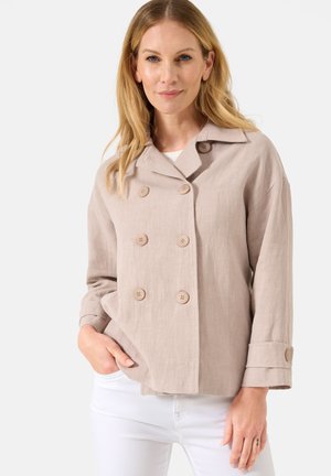 Lys beige linnedjakke med dobbeltbrystet design, store knapper og opsmøgede ærmer. Glat tekstur og skræddersyet pasform.