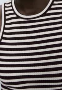 Black and white striped sleeveless top made of ribbed fabric, featuring a rounded neckline and horizontal lines of varying widths.
