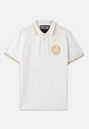 White polo shirt made of cotton, featuring a gold-trimmed collar, three buttons, and a circular embroidered logo on the left chest.